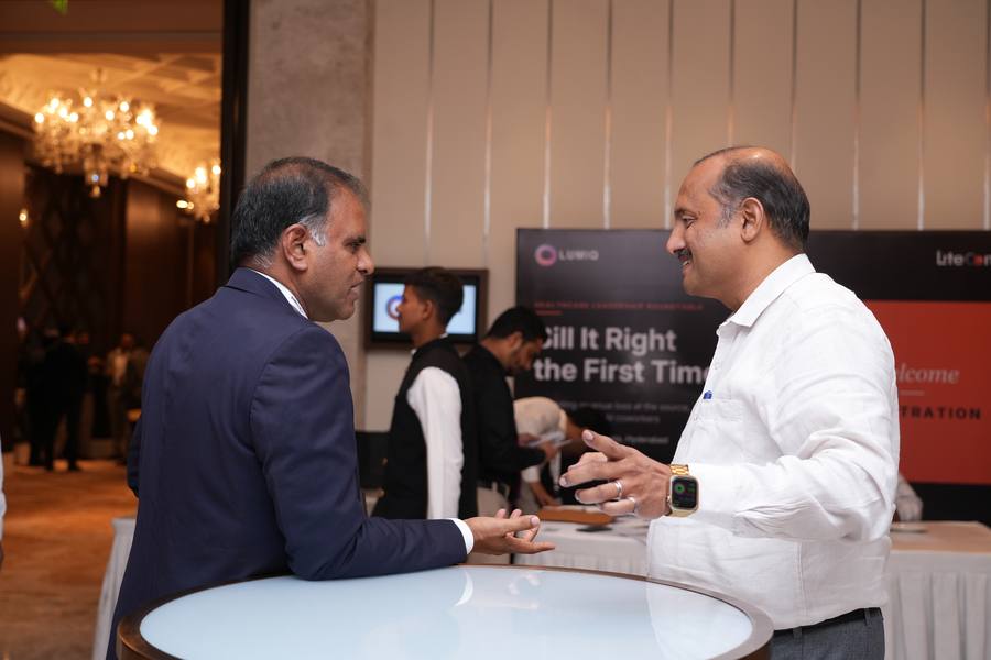 Two guests talking by the registration area